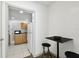 Cozy kitchen nook with a refrigerator, wood cabinets, and a small dining set at 3324 W Saint Joseph St, Tampa, FL 33607