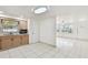 Well-lit kitchen with white floors and an open transition to the living room at 3324 W Saint Joseph St, Tampa, FL 33607