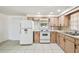 Fully-equipped kitchen with white appliances, tile floor, and ample cabinet space at 3324 W Saint Joseph St, Tampa, FL 33607