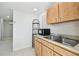 Kitchen area with stainless steel sink and wooden cabinets at 3324 W Saint Joseph St, Tampa, FL 33607