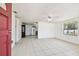 Bright living room boasts tile floors, a ceiling fan, and a large window, adjacent to the kitchen at 3324 W Saint Joseph St, Tampa, FL 33607