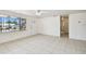 Bright living room features tiled floors, ample natural light from a large window and a entry door at 3324 W Saint Joseph St, Tampa, FL 33607
