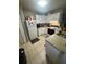 Efficient kitchen layout with white cabinets and essential appliances at 3710 N 57Th St, Tampa, FL 33619