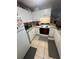 Compact kitchen area with white cabinets and modern black appliances at 3710 N 57Th St, Tampa, FL 33619