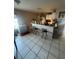 Compact kitchenette with bar seating and basic appliances at 3710 N 57Th St, Tampa, FL 33619
