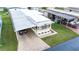 Eye-level shot featuring an adorable home with covered parking and an inviting patterned concrete driveway at 37105 Lois Ave, Zephyrhills, FL 33542