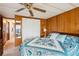 Comfortable bedroom featuring wood paneling, closet space and an inviting bed at 37105 Lois Ave, Zephyrhills, FL 33542