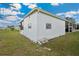 Well-maintained single-story house featuring a covered parking area and tidy yard at 37105 Lois Ave, Zephyrhills, FL 33542