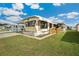 Cozy mobile home with well-kept lawn and wooden access ramp, ideal for comfortable living at 37105 Lois Ave, Zephyrhills, FL 33542