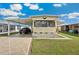 Charming single-story home featuring well-maintained lawn and covered parking at 37105 Lois Ave, Zephyrhills, FL 33542