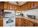 Traditional kitchen featuring wood cabinets, essential appliances, and a practical layout at 37105 Lois Ave, Zephyrhills, FL 33542