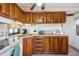 Functional kitchen with wooden cabinets, essential appliances, and plenty of counter space at 37105 Lois Ave, Zephyrhills, FL 33542