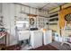 Functional laundry room featuring a sink, washer, dryer, and ample storage shelving at 37105 Lois Ave, Zephyrhills, FL 33542