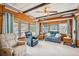 Bright living room featuring wood paneling, ceiling fan and natural light at 37105 Lois Ave, Zephyrhills, FL 33542