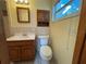 A traditional bathroom with a standard toilet, vanity, medicine cabinet, and tiled walls at 3762 18Th S Ter, St Petersburg, FL 33711