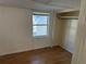 Well-lit bedroom featuring a window, a closet, neutral paint, and wood-look flooring creating a comfortable space at 3762 18Th S Ter, St Petersburg, FL 33711