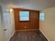 Bedroom featuring wood accent paneling, natural lighting, and wood-look flooring creating a warm atmosphere at 3762 18Th S Ter, St Petersburg, FL 33711