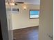 Bright bedroom featuring a ceiling fan, AC unit, a window offering natural light, and wood-look flooring at 3762 18Th S Ter, St Petersburg, FL 33711