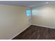 Bedroom with wood look flooring, window and small air conditioner for staying cool at 3762 18Th S Ter, St Petersburg, FL 33711