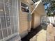 Tan home with white trim has a private entrance to the enclosed back yard at 3762 18Th S Ter, St Petersburg, FL 33711