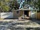 Tan home with white picket fence and partial covered porch with room to add personal touches at 3762 18Th S Ter, St Petersburg, FL 33711