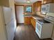 Functional kitchen featuring wood cabinetry, appliances, and wood-look flooring offering a practical culinary space at 3762 18Th S Ter, St Petersburg, FL 33711