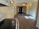 Open-concept living room with updated flooring, a ceiling fan, and natural light from the front door at 3762 18Th S Ter, St Petersburg, FL 33711