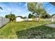 Large, fenced backyard with a storage shed, offering privacy and ample space for recreation and gardening at 3929 Cochise Ter, Sarasota, FL 34233