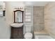 The remodeled bathroom has a modern vanity, mirror, and tiled shower and tub at 3929 Cochise Ter, Sarasota, FL 34233