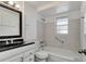 Bathroom features a bathtub with shower, a toilet, and a vanity with a sink at 3929 Cochise Ter, Sarasota, FL 34233