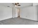 Bedroom featuring neutral carpet, a ceiling fan, and a doorway to the hall at 3929 Cochise Ter, Sarasota, FL 34233
