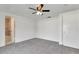 Bright bedroom with carpet floors, ceiling fan, and a view to an adjacent bathroom at 3929 Cochise Ter, Sarasota, FL 34233