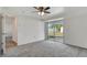 Bright bedroom with neutral carpet, ceiling fan, and sliding glass door to the backyard at 3929 Cochise Ter, Sarasota, FL 34233
