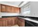 Kitchen featuring updated cabinets, granite counters and stainless sink with a window view at 3929 Cochise Ter, Sarasota, FL 34233