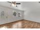 Sunlit living room boasts wood floors, fresh paint, a decorative front door and plenty of natural light at 3929 Cochise Ter, Sarasota, FL 34233