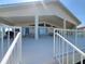 Spacious back porch with patio furniture and a grill, perfect for outdoor entertaining at 5025 Westshore Dr, New Port Richey, FL 34652
