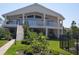 Beautiful two-story home with a large back porch, lush landscaping, and well-maintained lawn at 5025 Westshore Dr, New Port Richey, FL 34652