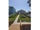 Beautifully landscaped backyard with walkway leading to the pool and waterfront at 5025 Westshore Dr, New Port Richey, FL 34652