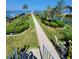 Beautifully landscaped backyard with walkway leading to the waterfront at 5025 Westshore Dr, New Port Richey, FL 34652