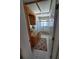 Bathroom with tile floors, wood cabinets, and an enclosed shower at 5025 Westshore Dr, New Port Richey, FL 34652