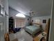 Bedroom featuring neutral walls, a vaulted ceiling, a ceiling fan and tile flooring at 5025 Westshore Dr, New Port Richey, FL 34652