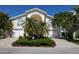 Two-story home with a well-manicured lawn, palm trees and a large driveway leading to two garages at 5025 Westshore Dr, New Port Richey, FL 34652