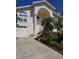 Two-story home with large staircase leading to front door with attached two car garage at 5025 Westshore Dr, New Port Richey, FL 34652