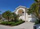 Charming two-story home with lush landscaping, front yard and attached two car garage at 5025 Westshore Dr, New Port Richey, FL 34652