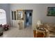 View of living room with tile floors, a mirror and a view into the entryway at 5025 Westshore Dr, New Port Richey, FL 34652