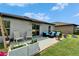 Outdoor patio with comfortable furniture, a fire pit, and sliding glass doors to the house at 5043 White Chicory Dr, Apollo Beach, FL 33572