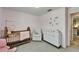 Bedroom with pink walls, crib and changing table at 5043 White Chicory Dr, Apollo Beach, FL 33572
