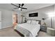 Comfortable bedroom with a queen-sized bed, ceiling fan, and ensuite bathroom access at 5043 White Chicory Dr, Apollo Beach, FL 33572