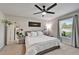 Calming bedroom with neutral tones, a ceiling fan, and natural light from the window at 5043 White Chicory Dr, Apollo Beach, FL 33572