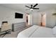 Modern bedroom featuring a sleek dresser, desk, and access to an ensuite bathroom with a shower at 5043 White Chicory Dr, Apollo Beach, FL 33572